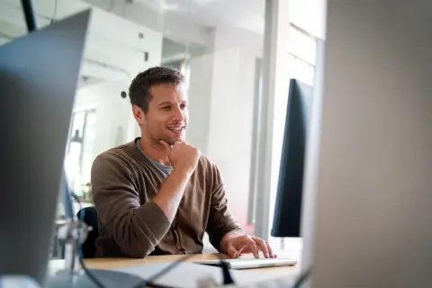 Business man behind computer